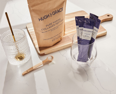 Our wellness set sitting on a cutting board next to a glass of water.
